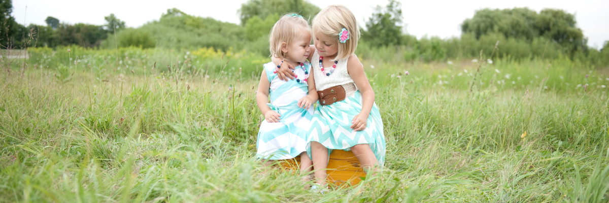 Two young sisters hugging