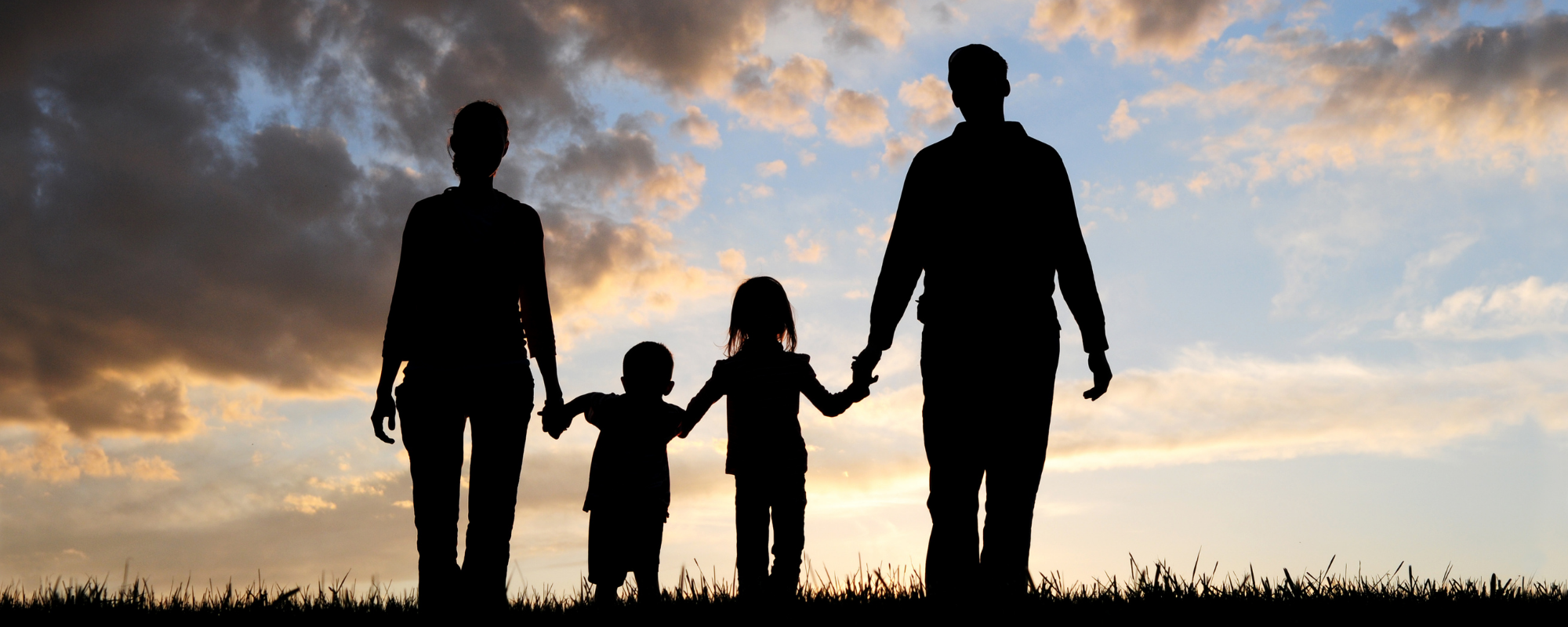 Adopters Laura and Adam in silhouette with their children