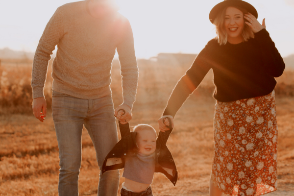 Couple swinging child between them