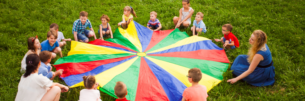 Children and adults playing a parachute game