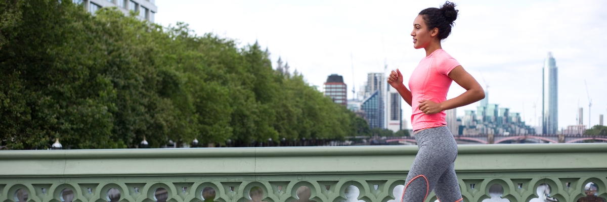 Young woman running across Westminster Bridge