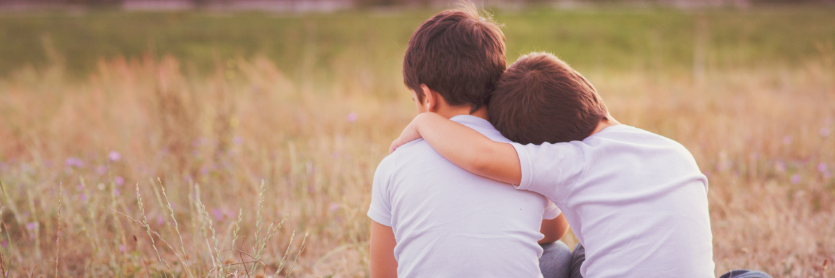 brothers wearing the same outfit looking away from the camera