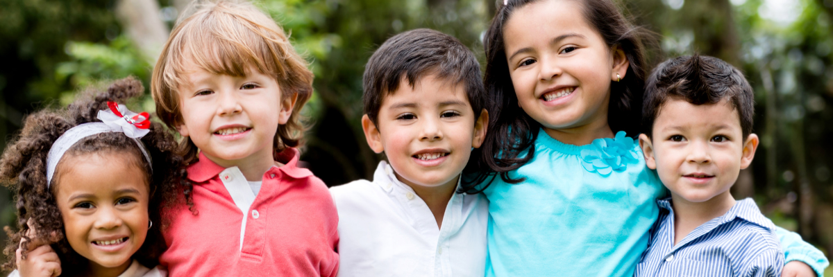 Boys and girls in a line, smiling for a photograph