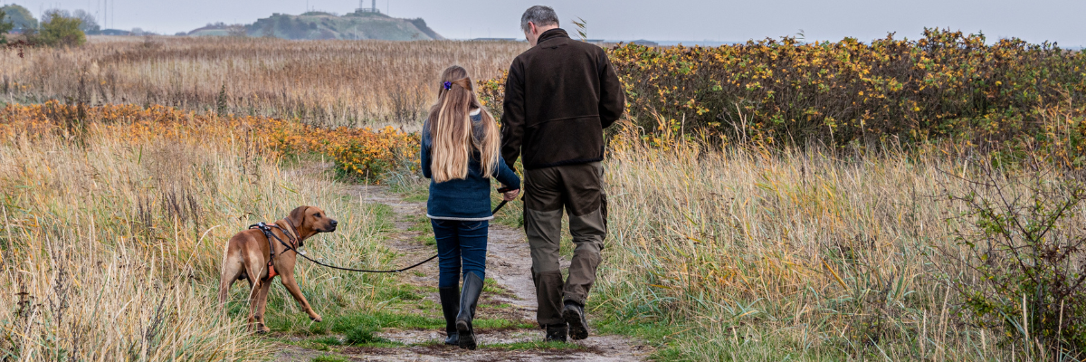 Dad and Teenage Daughter walking a dog