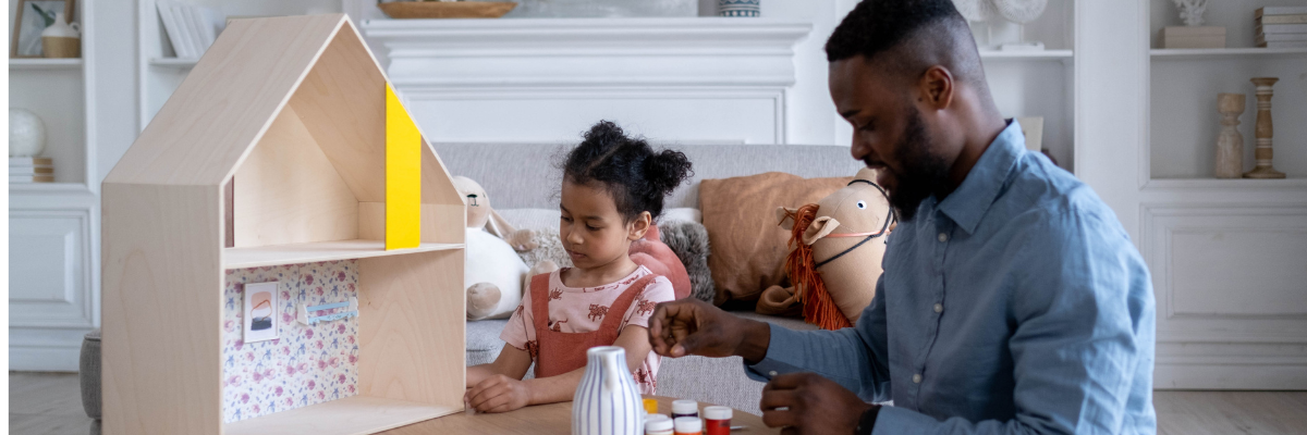Dad and daughter making a dolls house