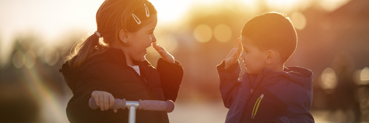 A boy and a girl high fiving