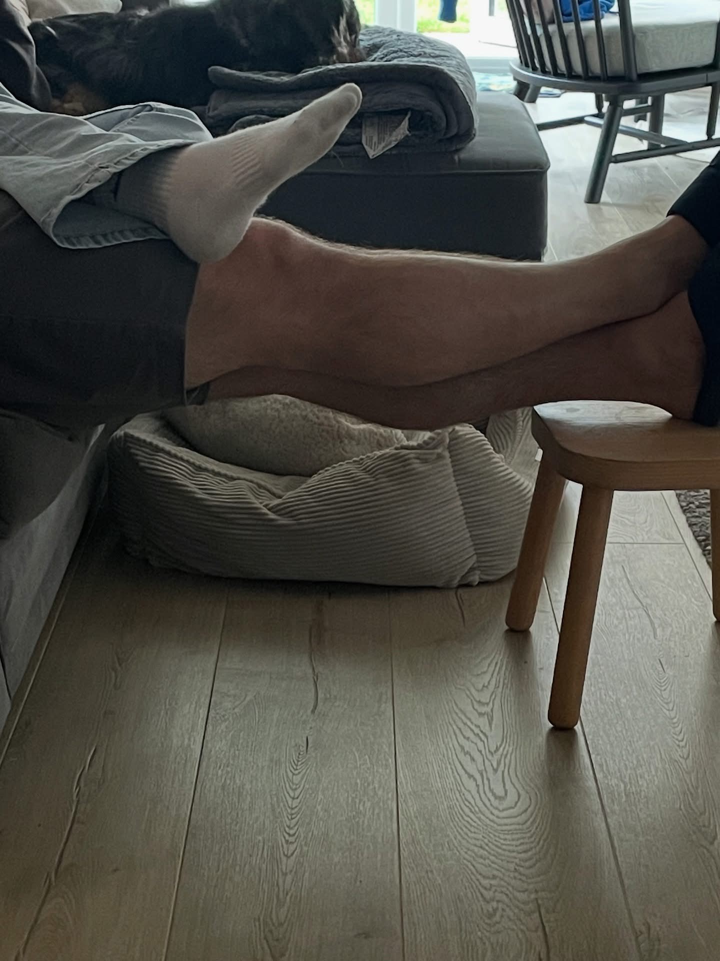 A teenage girl foot resting on her dad's leg