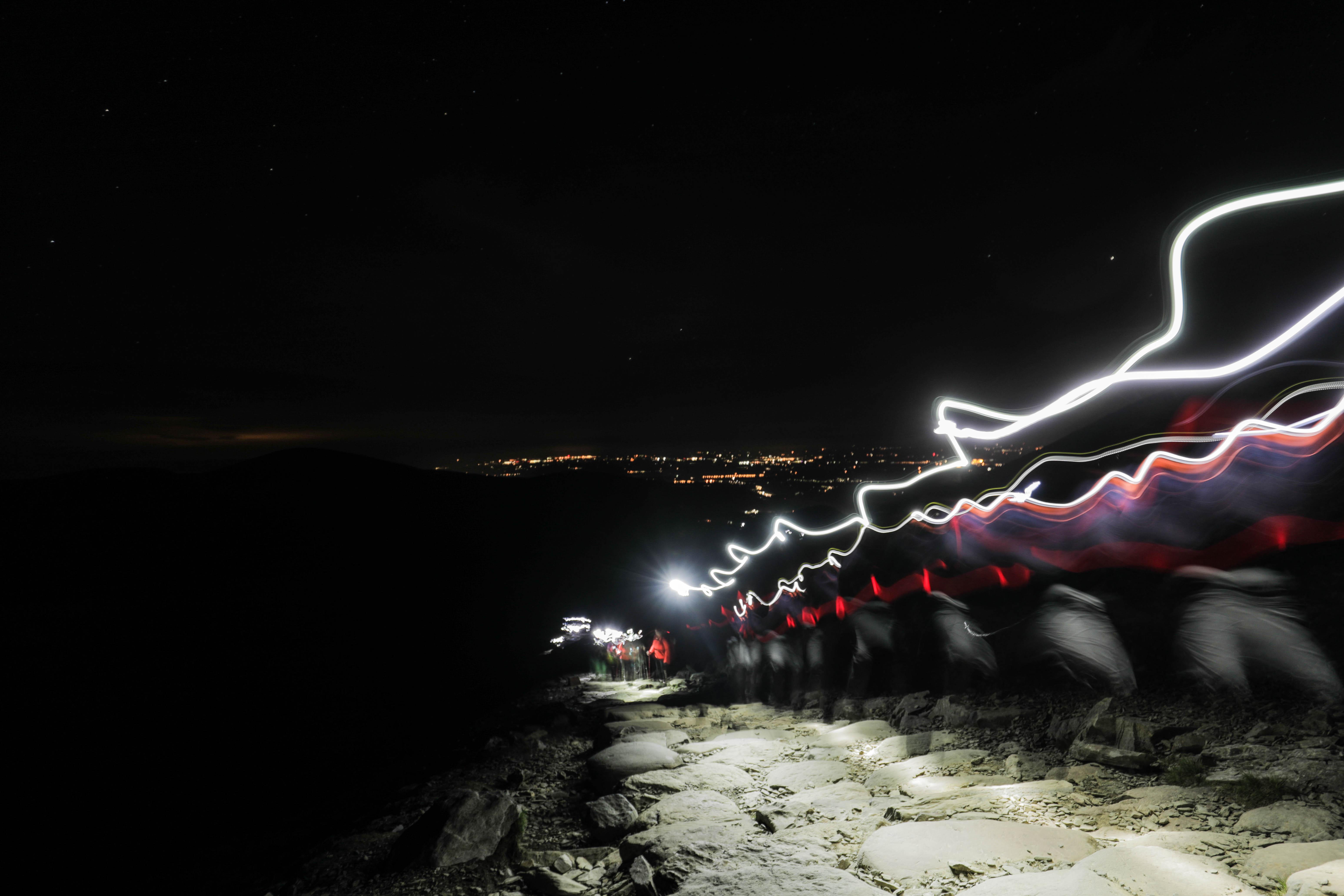 lights stream from the head torches at night